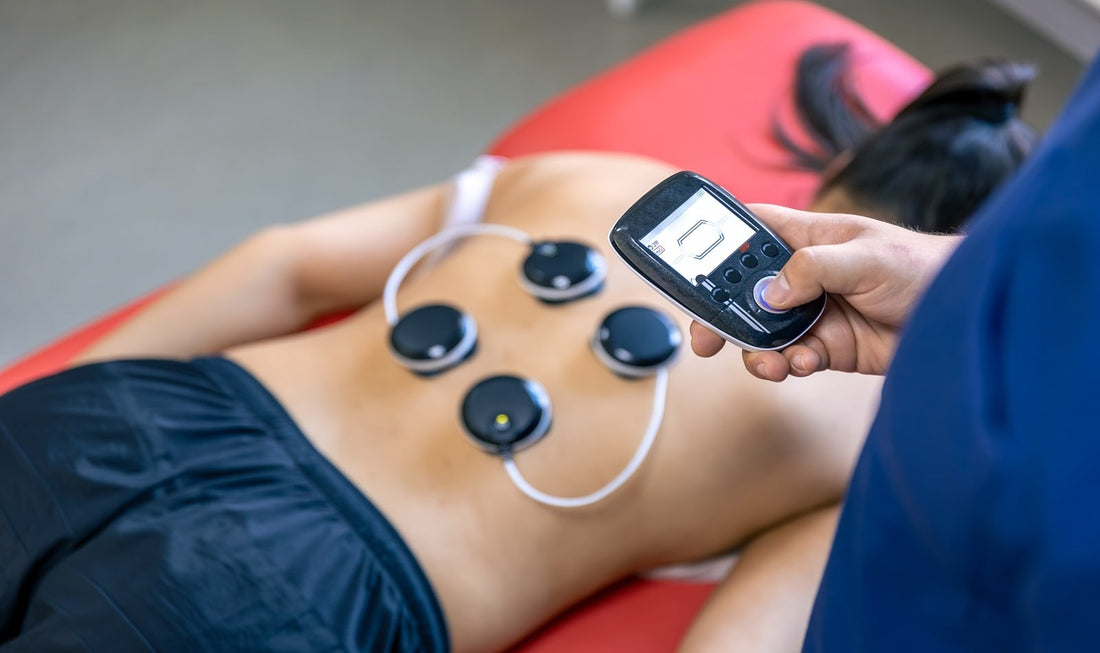 Patiente en séance de rééducation musculaire par électrodes