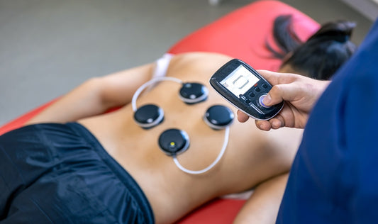 Patiente en séance de rééducation musculaire par électrodes